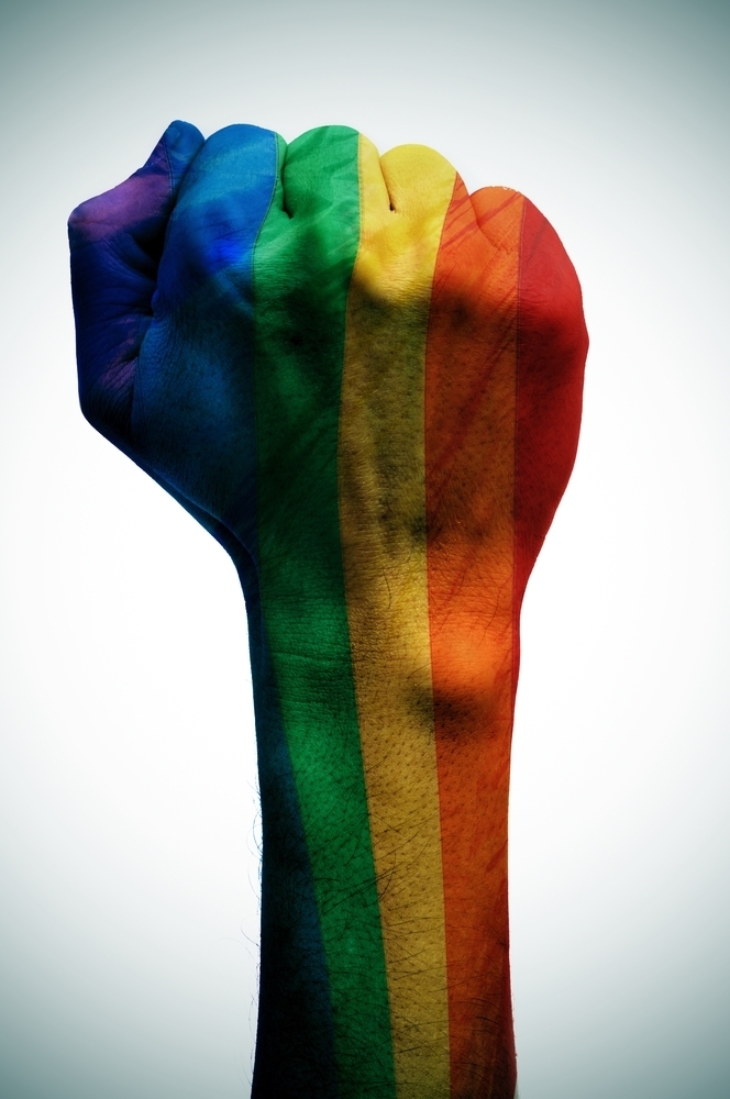 raised fist patterned with the rainbow flag, symbolizing the fight for gay rights