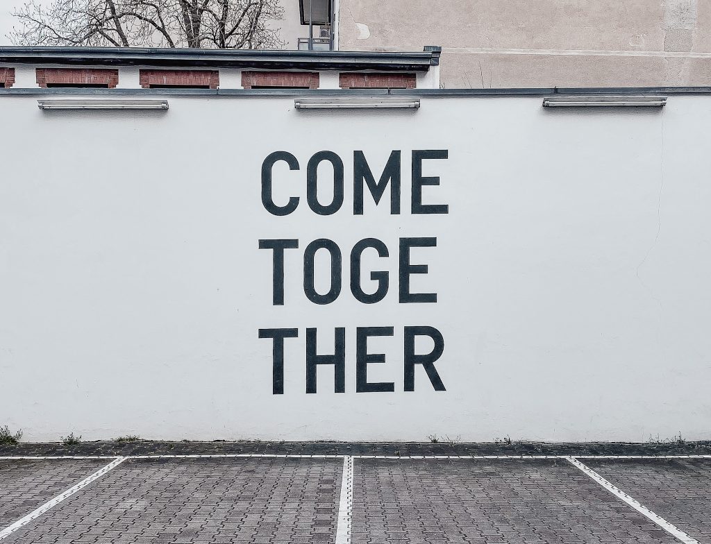 Photo of wall in Berlin with "Come Together" in typeface